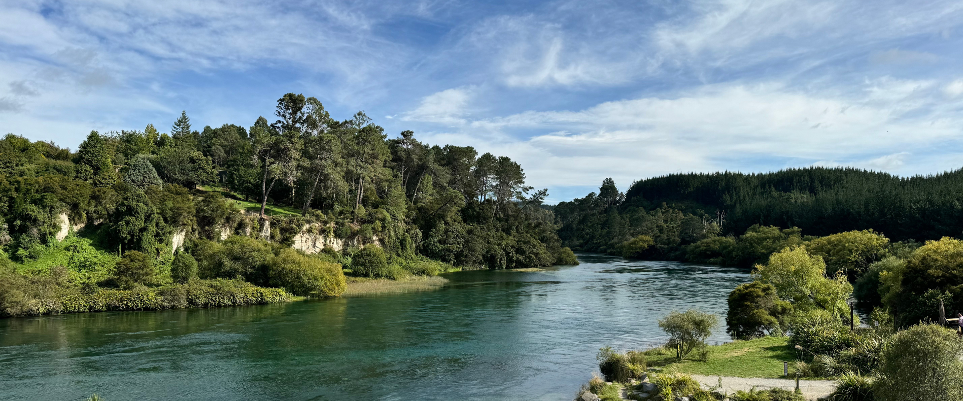 Lake Taupo river with blue water and trees