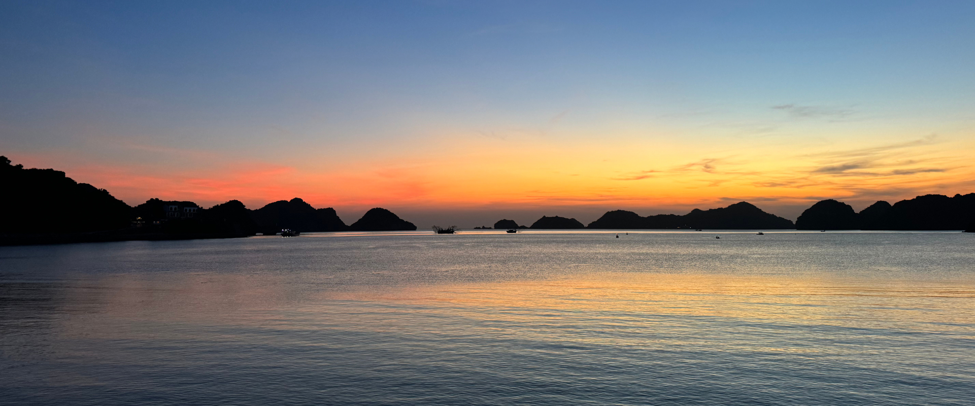 Best places to visit Vietnam, Cat ba island with the sea at sunset with limestone hills in the background